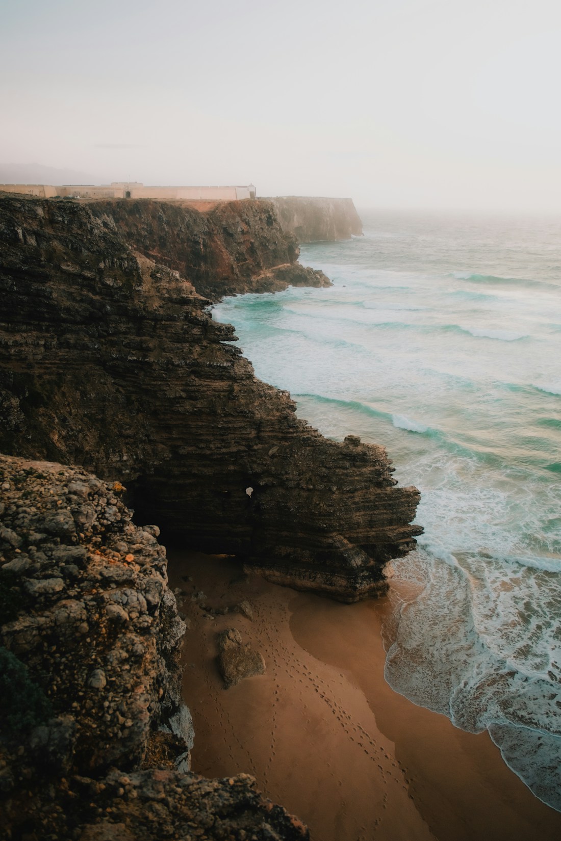 Atlantic waves meeting a sheltered sandy cove on Portugal’s Algarve coast