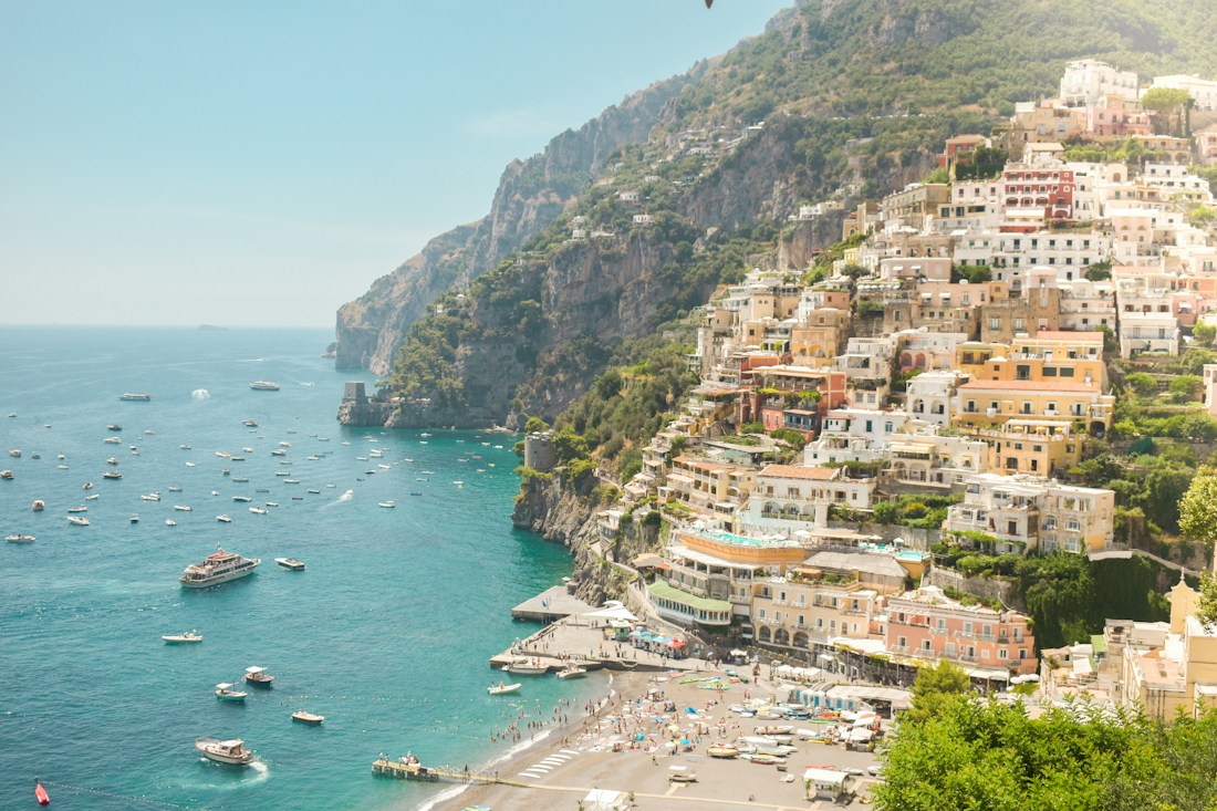 Colourful hillside houses above the sparkling sea in Positano, Italy